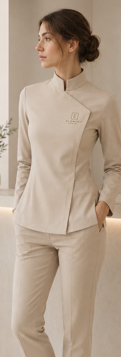 Team member in the sand-tone Restoro uniform concept — tailored jacket and trousers